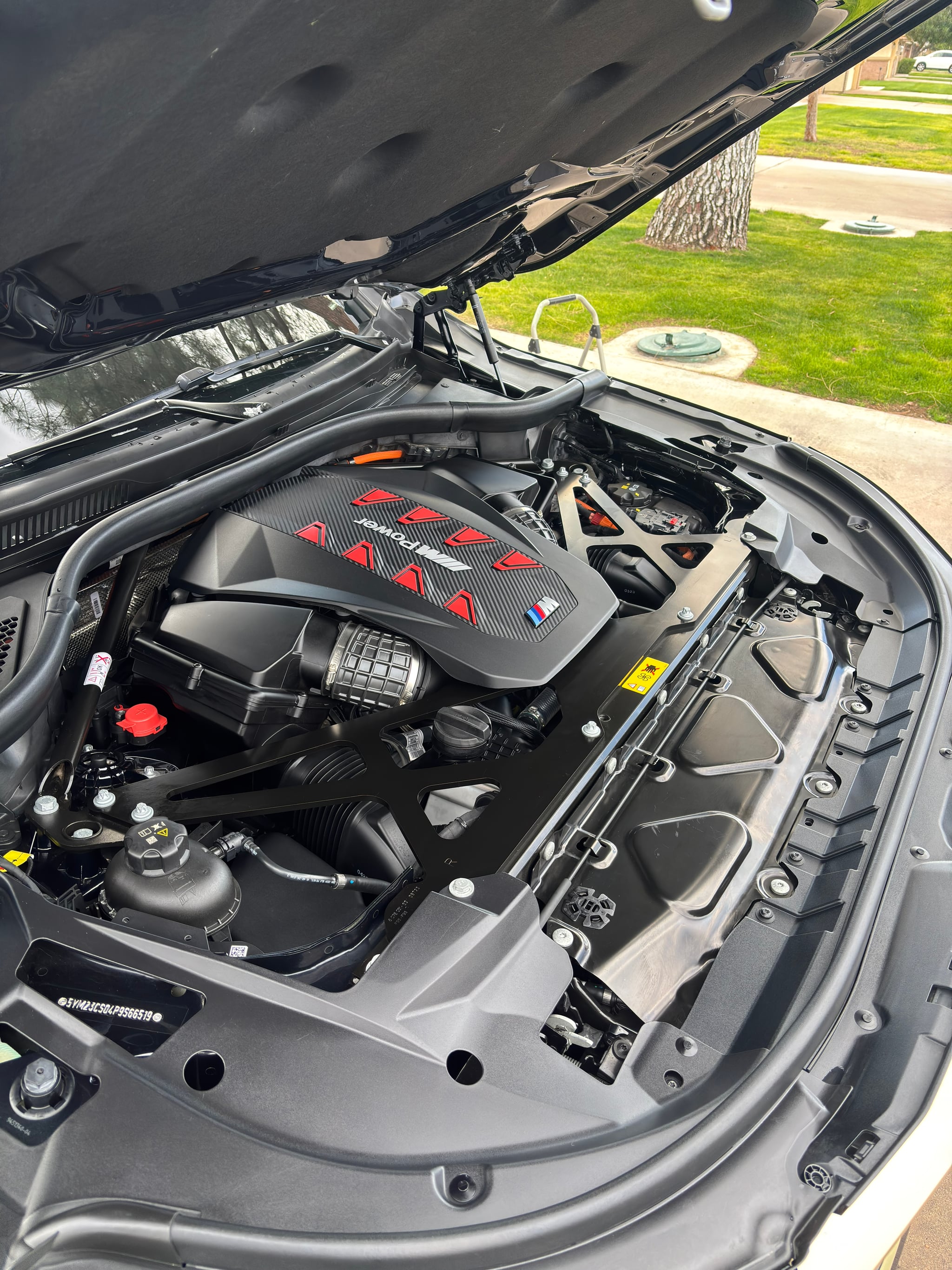 Professional engine bay detailing showing clean engine compartment